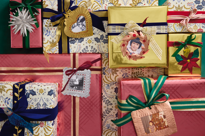 Christmas gifts wrapped in a vintage style with metallic plaid and multicolor toile patterns, with DIY metallic gift tags that include vintage childhood photos of the intended gift recipient.